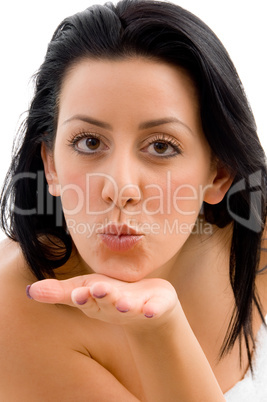 front view of female giving flying kiss on an isolated background