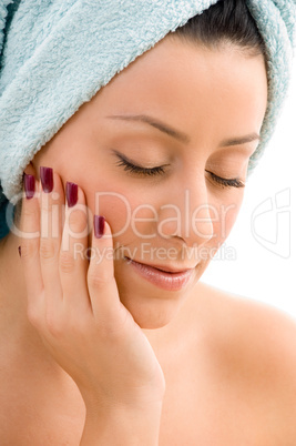 front view of female touching her face against white background