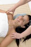 top view of smiling woman taking massage