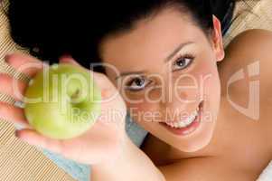 high angle view of smiling woman offering apple on an isolated background