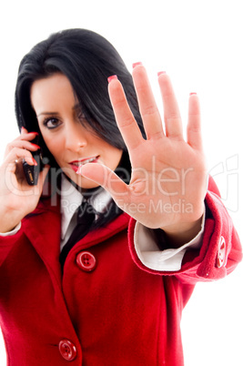 american woman interacting on cell phone and showing stopping gesture