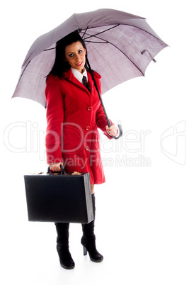 american woman holding an umbrella and office bag