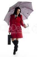 full body pose of caucasian female holding briefcase and umbrella