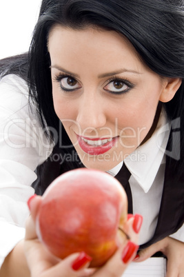 young student holding an apple