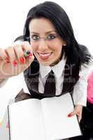 student with study material pointing with her pen