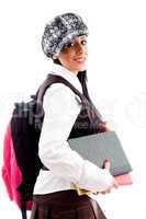 female student in cap with her school bag and study material