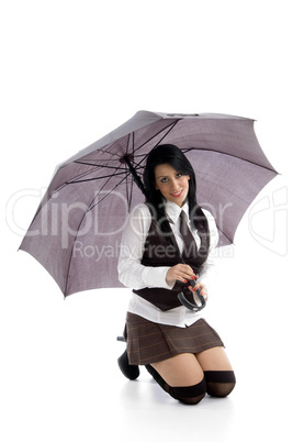 young female kneeling down on floor holding umbrella