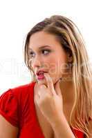 woman biting her finger and looking sideways