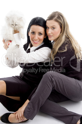 young woman holding her pet cat and looking at camera