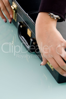 hands holding suitcase