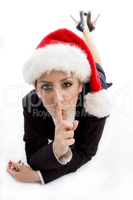 businesswoman with christmas hat instructing to keep silent
