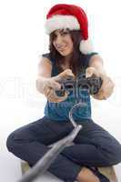young woman with remote and christmas hat
