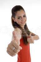 smiling girl with beautiful hairstyle showing thumb gesture