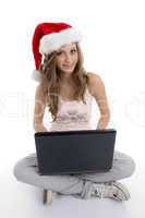 smiling school girl with christmas hat and laptop