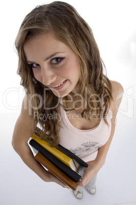 young student with books looking upward