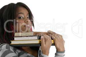 girl keeping her chin on books