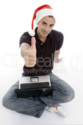 caucasian man with laptop and christmas hat