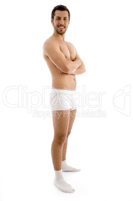standing shirtless male with folded hands
