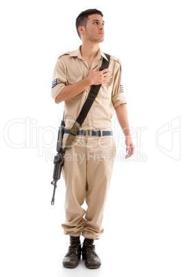 standing soldier with gun putting hand on his chest
