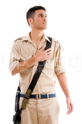 soldier with gun putting hand on his chest