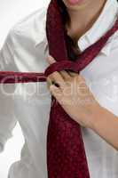 young pretty woman tying her tie
