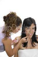 beautician doing makeup on female face