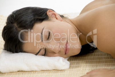 young woman sleeping on mat