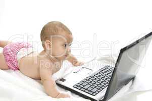 young baby playing with laptop