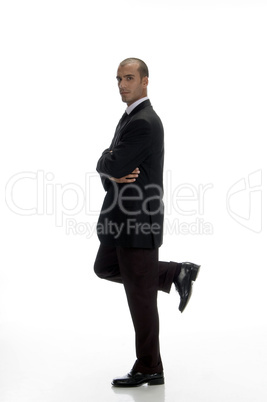 young businessman standing on one leg