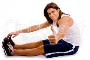 side view of exercising man with thumbs up