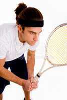 side pose of male playing tennis