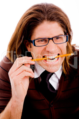 portrait of young male holding pencil with teeth