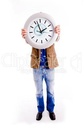 front view of young man hiding his face with watch