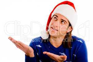 portrait of man wearing christmas hat and presenting