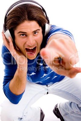 top view of shouting male enjoying music and pointing