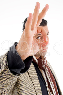 man in coat making ok hand gesture