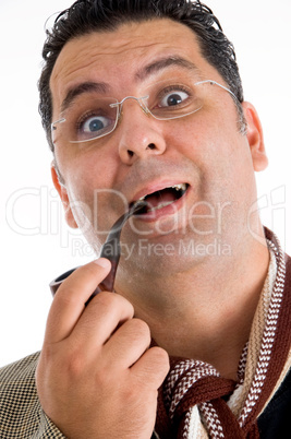 man holding tobacco pipe giving amazed expression