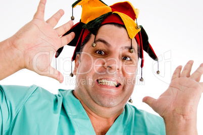 adult doctor wearing colorful hat giving screaming expression