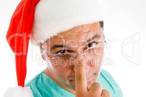 doctor wearing santa hat adjusting his spctacles