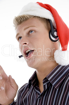 close up of man interacting through headset wearing santa hat