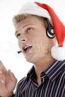 close up of man interacting through headset wearing santa hat