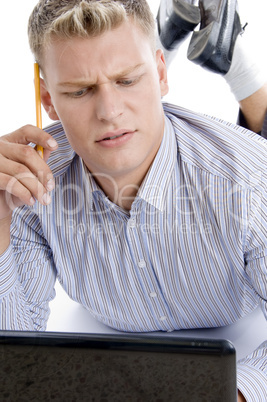 thinking man with laptop and pencil