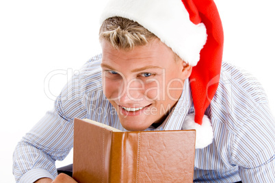 pleased man with book and christmas hat