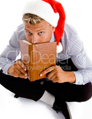 sitting man with book and christmas hat