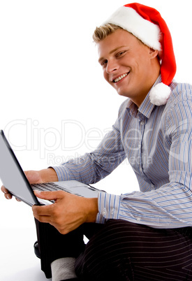 happy man with christmas hat and laptop