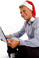 happy man with christmas hat and laptop