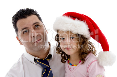 girl wearing christmas hat posing with her father
