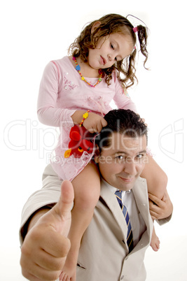 cute girl sitting on the father's shoulders