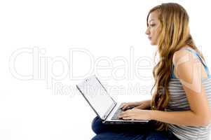blonde female student working on laptop