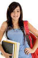 student posing with bag and books